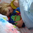 Load image into Gallery viewer, girl asleep with potato monster tooth pillow