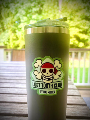 lost tooth club skull and crossbones sticker on a water cup