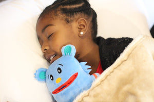 Girl asleep with blue tooth pillow monster